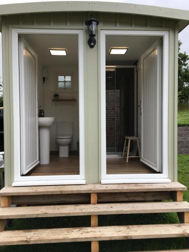 two windows on the front of a tiny house at CEDAR CAMPING POD in Great Ayton