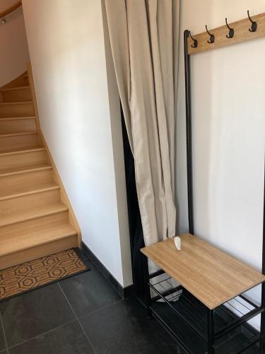a stairwell with a wooden table and a curtain at L'appartementducroisic - Sur le port, vue mer in Le Croisic