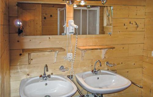 a bathroom with two sinks and a mirror at Three-Bedroom Holiday Home In Unterweissenbach in Unterweissenbach