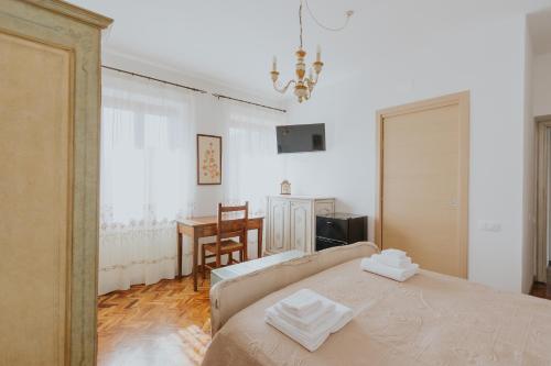 Schlafzimmer mit einem Bett, einem Tisch und einem Schreibtisch in der Unterkunft La Tana dei Tassi in Ascoli Piceno