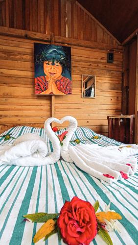 two swans making a heart on a bed at Eco-Hotel Mayachik in San Juan La Laguna