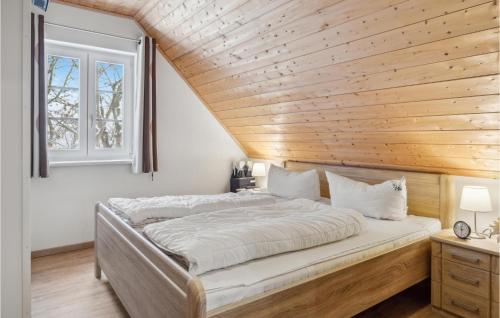 アルテフェーアにあるFerienhaus 44 Altefhrの木製天井の客室の大型ベッド1台分です。