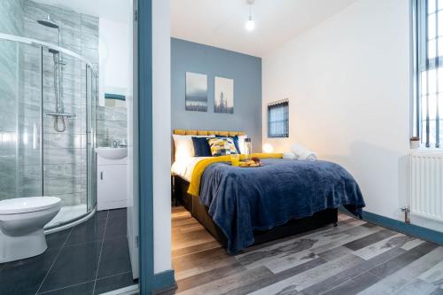 a bedroom with a bed and a shower and a toilet at Sky Rooms One Bedroom Modern Studio Apartment 3 in Birmingham