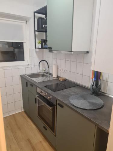 a kitchen with a sink and a counter top at Schöne 2 Zimmer Apartment in Uerdingen Nähe Düsseldorf in Krefeld