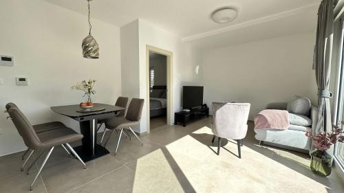 a living room with a table and a bedroom at Arte Oliva in Grebaštica
