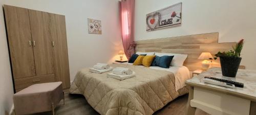 a bedroom with a bed with two towels on it at B&B A Modo Mio in Marsala