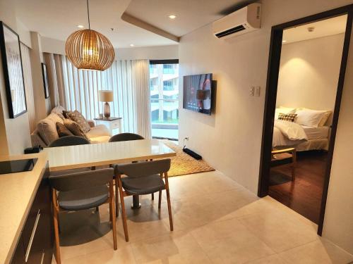 a kitchen and living room with a table and chairs at Tambuli Seaside Resort Residences in Lapu Lapu City