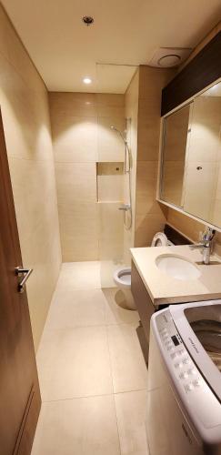 a bathroom with a shower and a sink and a toilet at Tambuli Seaside Residences Private Hosting Tower D Condominium in Lapu Lapu City
