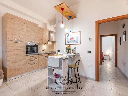 a kitchen with wooden cabinets and a counter top at BellaVita Apartments in Assemini