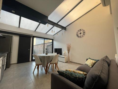 a living room with a couch and a table at Le Secret d'Agathe in Amiens
