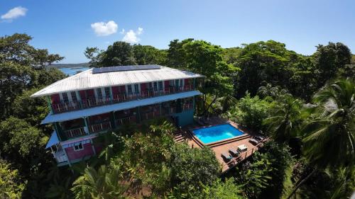an aerial view of a house in the forest at Los Secretos Guesthouse in Bocas Town