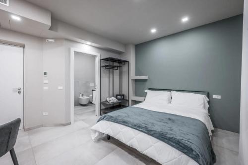 a bedroom with a large bed and a bathroom at Borgo degli Ulivi in Formigine