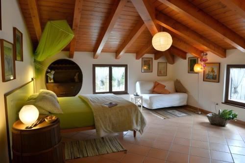 a bedroom with a bed and a couch in a room at Il Laghello di Amina in Framura