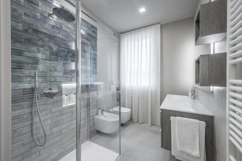 a bathroom with a shower and a toilet and a sink at Borgo degli Ulivi in Formigine
