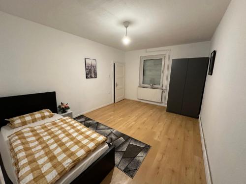a bedroom with a bed with a checkered blanket at Appartment for Rent 02 in Burgwedel