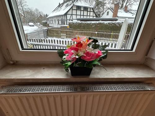 a vase of flowers sitting on a window sill at Appartment for Rent 02 in Burgwedel