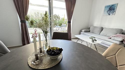a living room with a table and a couch at Arte Oliva in Grebaštica
