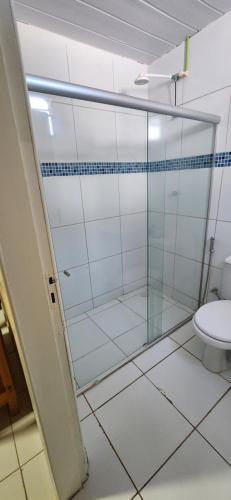 a bathroom with a glass shower with a toilet at Pousada do Trinta in Fernando de Noronha