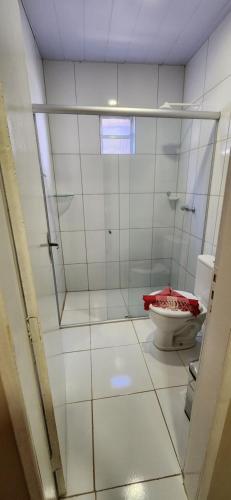 a white bathroom with a toilet and a window at Pousada do Trinta in Fernando de Noronha