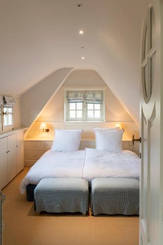 two beds in a room with a attic at Sunbeam, familievilla in Knokke-Zoute in Knokke-Heist