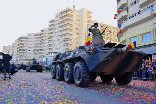 a group of military vehicles driving down a street at Studio PANORAMIC with Balcony and Parcul Unirii view in Alba Iulia