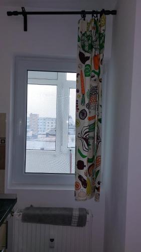 a window in a room with a window curtain with a view at Garsoniera Relax Drumul Taberei in Bucharest