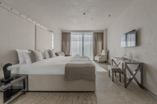 オデッサにあるSfumato Roomsの大きなベッドとデスクが備わるホテルルームです。