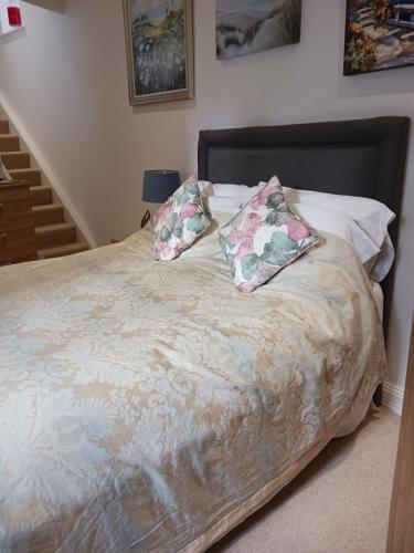 a bed with two pillows on top of it at BODLONDEB CASTLE BED & BREAKFAST { CENTRAL LLANDUDNO} in Llandudno