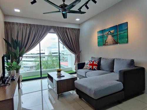 a living room with a couch and a table at PoolView Waterpark 300Mbps Ipoh Homestay Manhattan Condo 4-7pax 3bedroom Station 18 pengkalan in Ipoh
