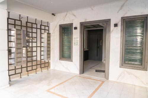 a hallway of a house with a door and windows at THE WHOLE PACKET A5 center with parking in Larisa
