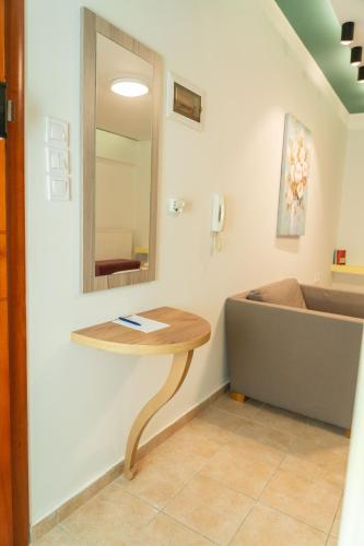 a bathroom with a table and a mirror on the wall at THE WHOLE PACKET A5 center with parking in Larisa