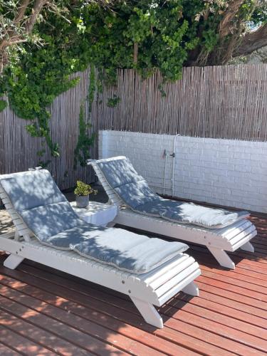 two lounge chairs sitting on top of a deck at Sail Away Studios in Simonʼs Town