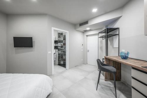 a bedroom with a bed and a desk with a chair at Borgo degli Ulivi in Formigine