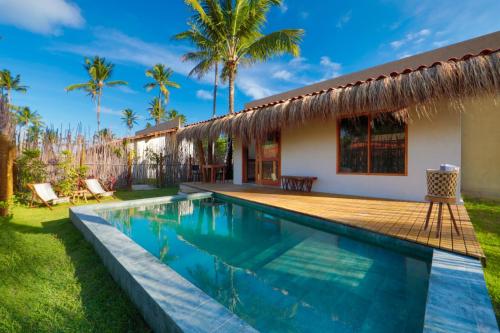 a villa with a swimming pool and a house at MONAN BOUTIQUE HOTEL in Pôrto de Pedras