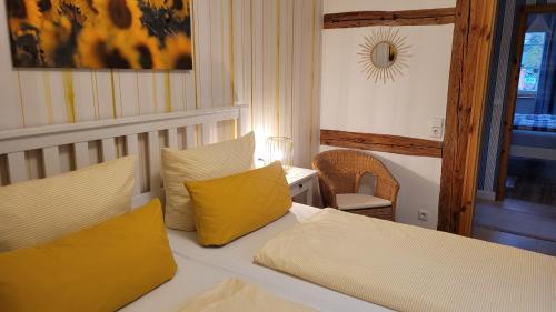 a bedroom with a bed with two yellow pillows at Im alten Rathaus in Bad Liebenstein