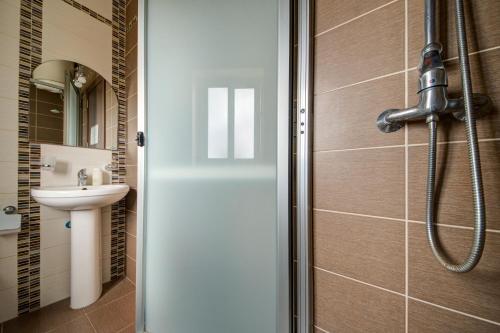 a bathroom with a shower with a toilet and a sink at CityScape Gzira Holiday Apartments and Penthouse in Il-Gżira