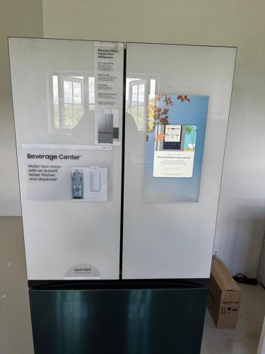 a refrigerator in a room with signs on it at NEW Luxury VILLA CapEstate Saint Lucia Ocean View in Cap Estate