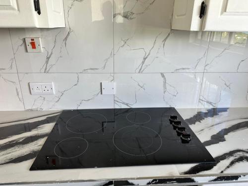 a kitchen with a black counter top in a kitchen at NEW Luxury VILLA CapEstate Saint Lucia Ocean View in Cap Estate