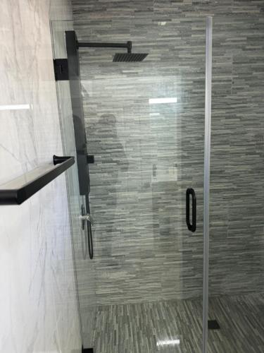 a shower with a glass door in a bathroom at NEW Luxury VILLA CapEstate Saint Lucia Ocean View in Cap Estate