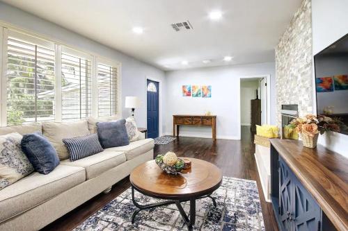 a living room with a couch and a table at Heart of NPB in North Palm Beach