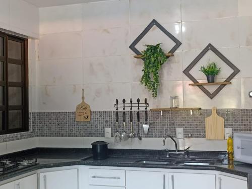 a kitchen with a sink and a counter top at Residencial Vista Bela in Bombinhas