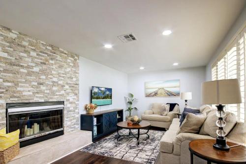 a living room with a couch and a fireplace at Heart of NPB in North Palm Beach