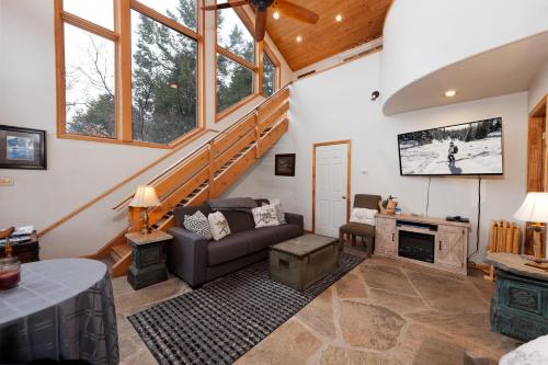 a living room with a couch and a tv at CR 213 - Combo in Durango