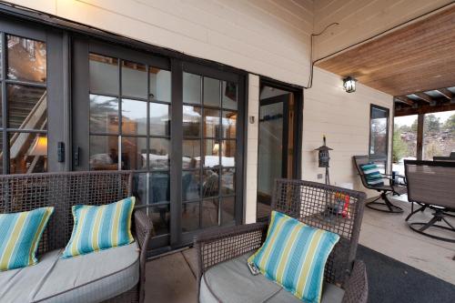 a porch with two wicker chairs and windows at CR 213 - Combo in Durango