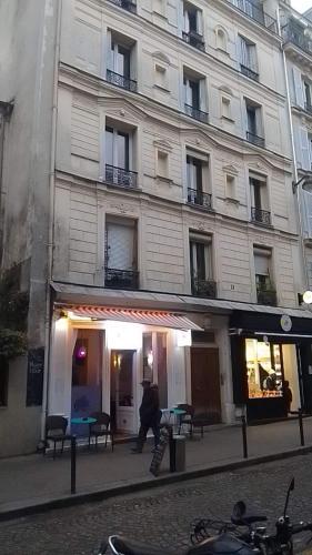 un homme marchant devant un bâtiment dans l'établissement Au pied du Sacré Cœur, à Paris