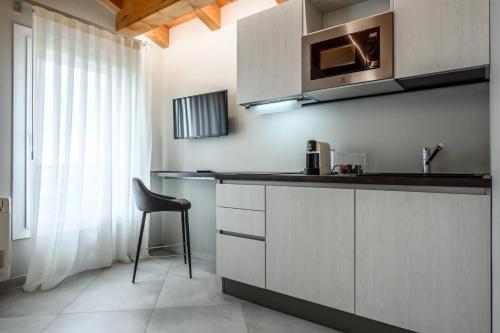 a kitchen with a counter and a chair in it at Borgo degli Ulivi in Formigine