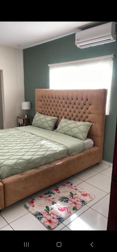 um quarto com uma cama grande, uma cabeceira e um tapete em Loft Toronjal Studio em La Ceiba