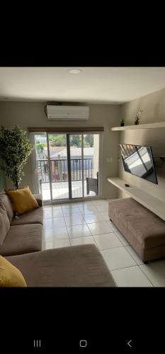 a living room with a couch and a large window at Loft Toronjal Studio in La Ceiba