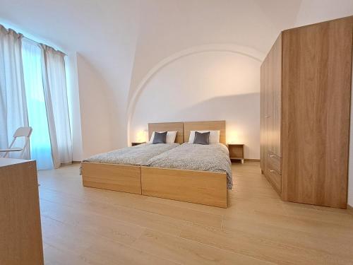 una camera con un grande letto e una grande finestra di la casa sull arco a Lucera