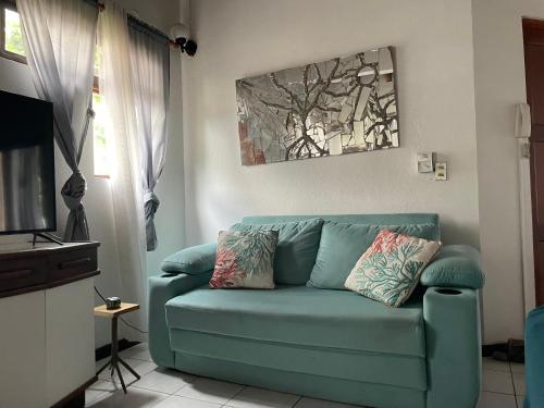 a living room with a blue couch in front of a window at Villa Hermosa in Playa Hermosa